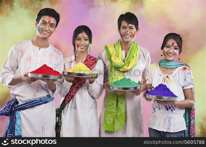 Friends holding trays with colours