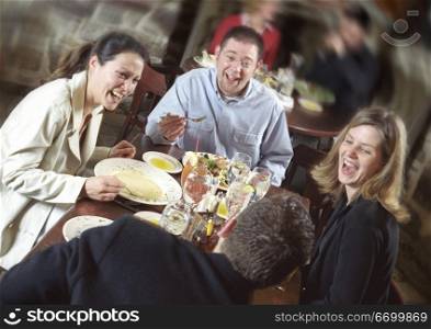 Friends Laughing Over Dinner
