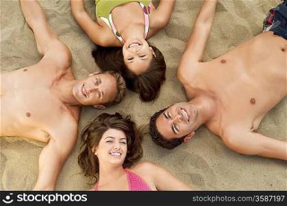 Friends Lying Down on Sand Together