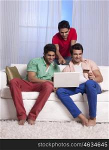 Friends making an online transaction with a credit card
