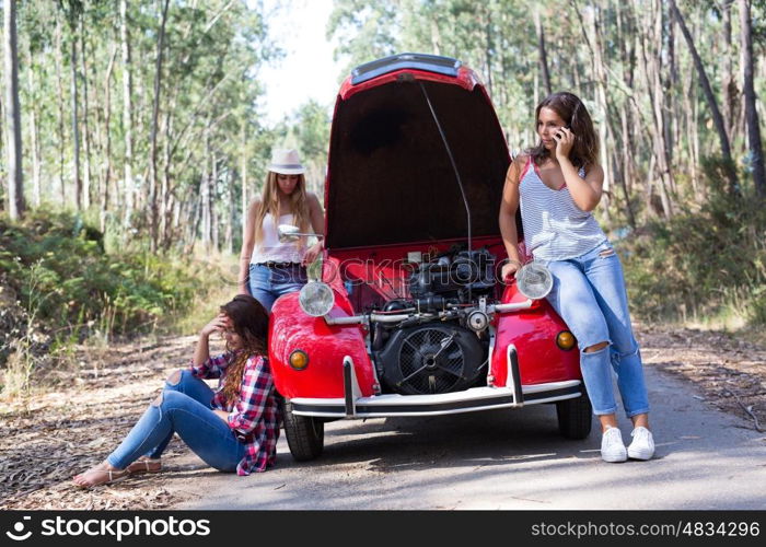 Friends on a roadtrip having a problem with their old car