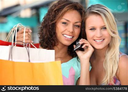 Friends out shopping with a cellphone