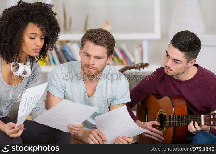 friends playing electric guitar piano and singing