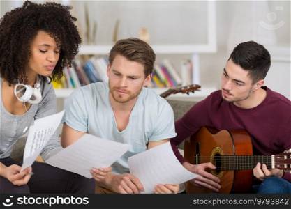 friends playing electric guitar piano and singing