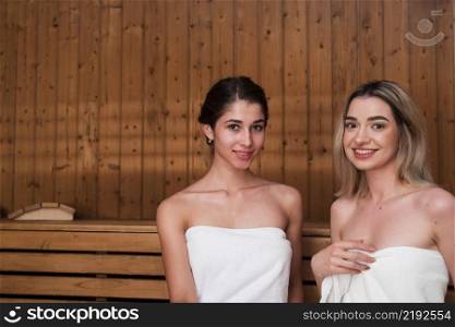 friends posing relaxed sauna