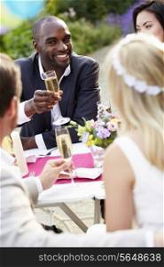 Friends Proposing Champagne Toast At Wedding