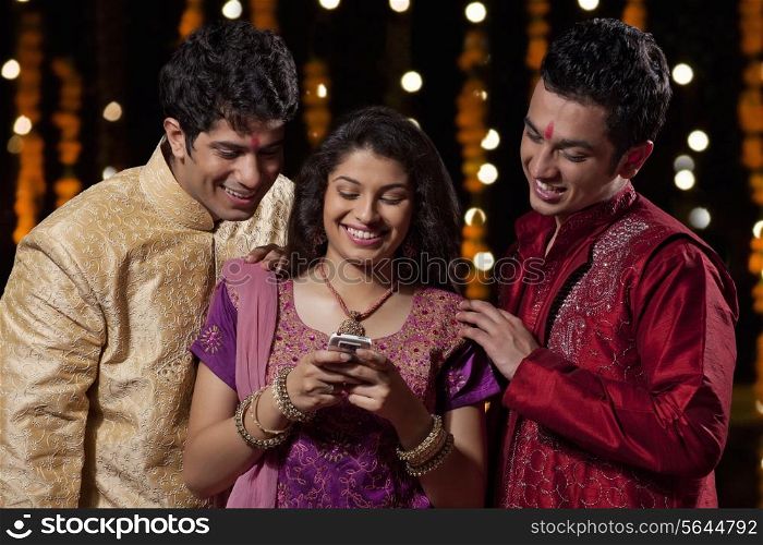 Friends reading an sms on a mobile phone