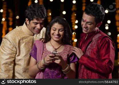 Friends reading an sms on a mobile phone