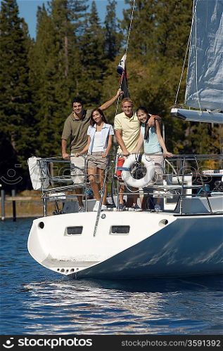 Friends Standing on Stern of Sailboat
