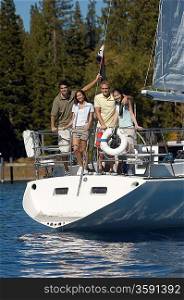 Friends Standing on Stern of Sailboat