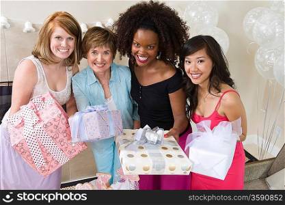 Friends standing Together holding gifts at party