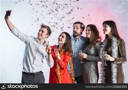 friends taking selfie new year party