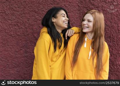 friends talking while wearing yellow hoodies