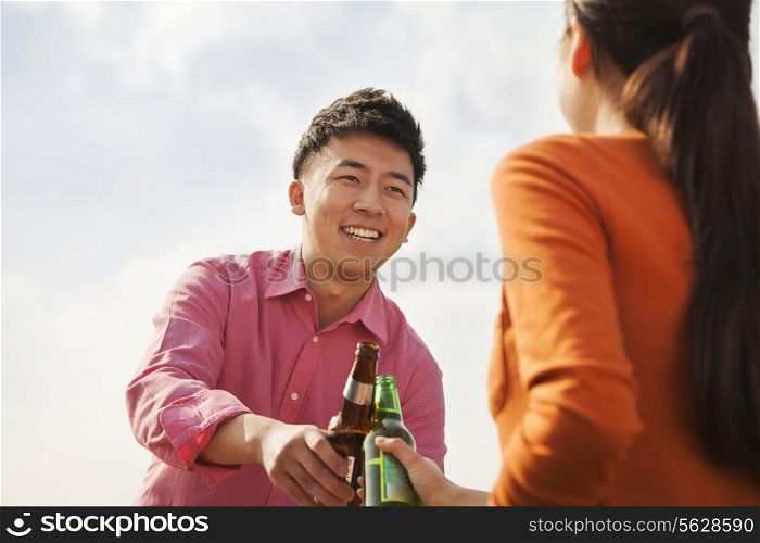 Friends Toasting Each Other on a Rooftop