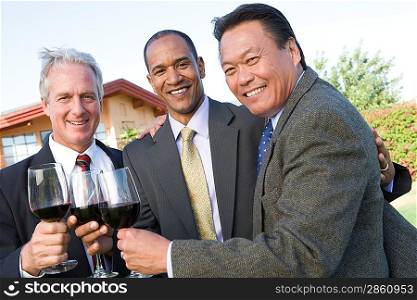 Friends toasting with wine in garden
