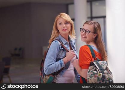 friends together at school, two student girls with backpack and tablet on university