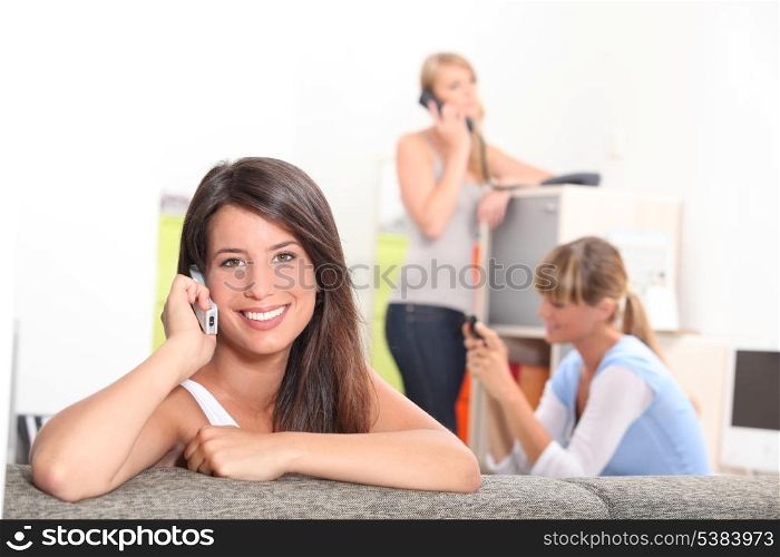 Friends using phones at home