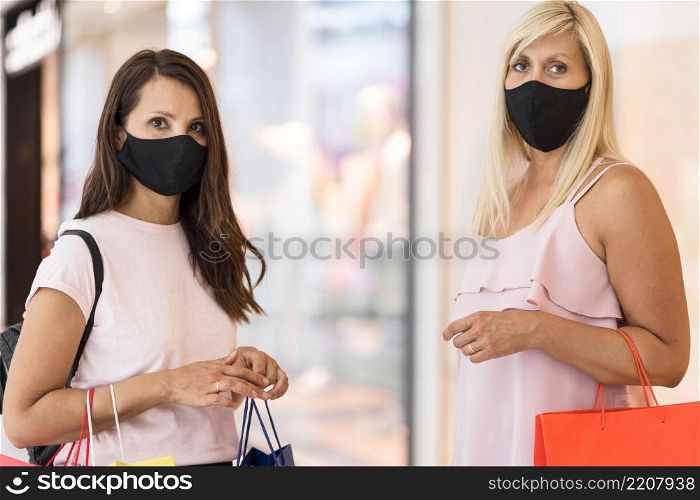 friends wearing fabric masks mall