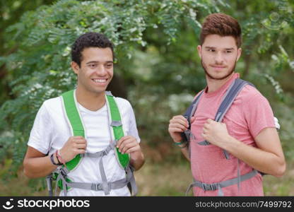 friends with backpacks in the forest