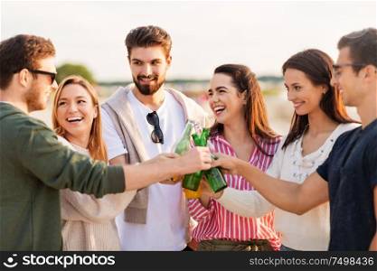 friendship and leisure concept - group of happy friends toasting non alcoholic drinks on summer beach. friends toasting non alcoholic drinks on beach