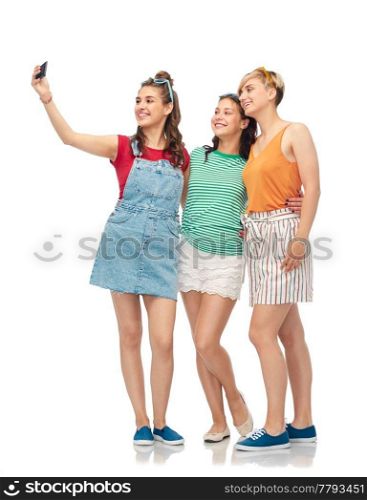 friendship and people concept - group of happy female smiling friends taking selfie by smartphone over white background. happy female friends taking selfie by smartphone