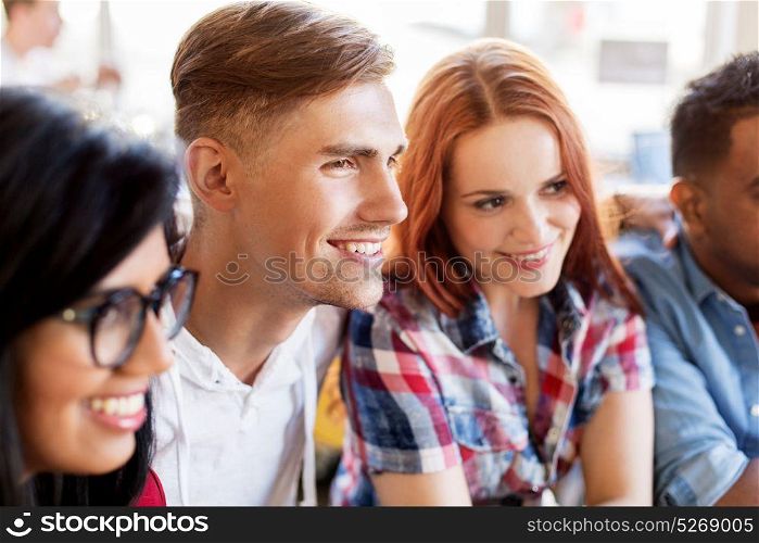 friendship and people concept - group of happy international friends at restaurant. happy friends at restaurant