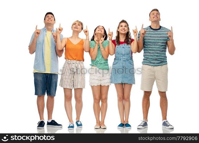 friendship and people concept - group of happy smiling friends looking and pointing fingers up over white background. friends looking and pointing fingers up