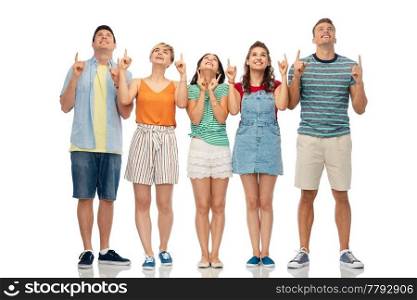 friendship and people concept - group of happy smiling friends looking and pointing fingers up over white background. friends looking and pointing fingers up