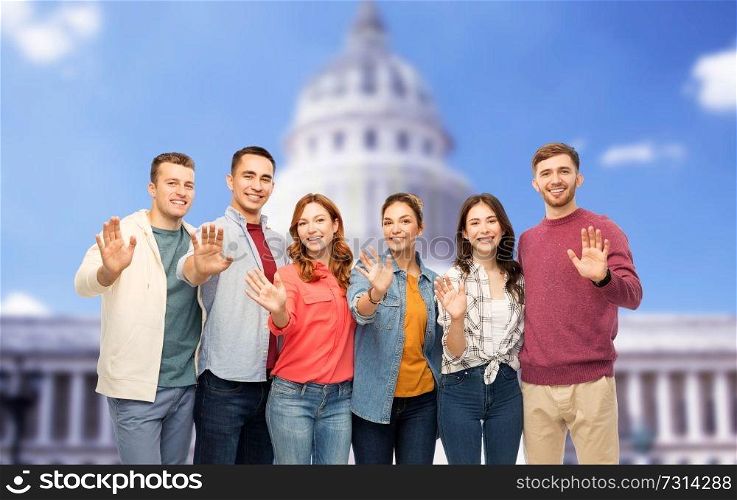 friendship and people concept - group of smiling friends over capitol building background. group of smiling friends over capitol building