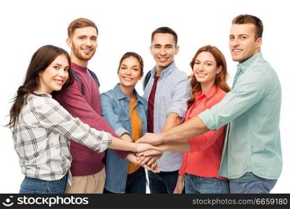 friendship and people concept - group of smiling friends stacking hands over white background. group of smiling friends stacking hands