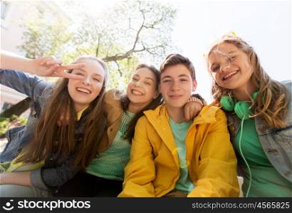 friendship and people concept - happy teenage friends or high school students having fun and making faces. happy teenage students or friends having fun