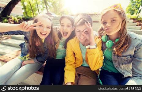 friendship and people concept - happy teenage friends or high school students having fun and making faces. happy teenage students or friends having fun. happy teenage students or friends having fun
