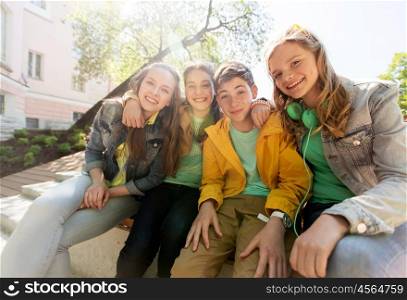 friendship and people concept - happy teenage friends or high school students hugging. happy teenage students or friends hugging
