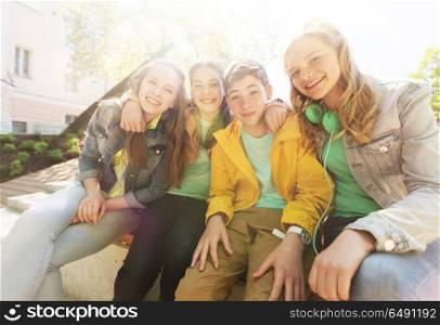 friendship and people concept - happy teenage friends or high school students hugging. happy teenage students or friends hugging. happy teenage students or friends hugging