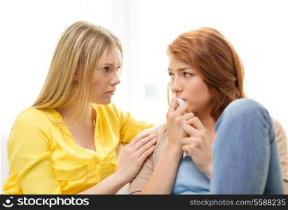 friendship and people concept - one teenage girl comforting another after break up