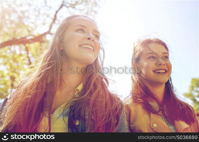 friendship and people concept - portrait of two happy teenage student girls or friends outdoors. happy teenage student girls or friends outdoors