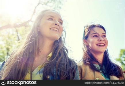 friendship and people concept - portrait of two happy teenage student girls or friends outdoors. happy teenage student girls or friends outdoors. happy teenage student girls or friends outdoors