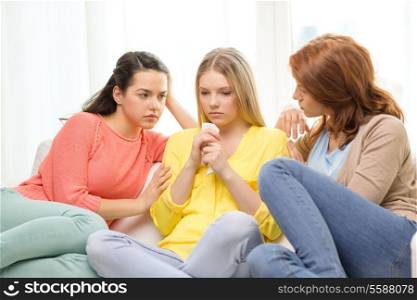 friendship and people concept - two teenage girls comforting another after break up