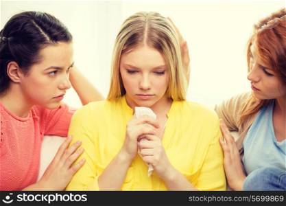 friendship and people concept - two teenage girls comforting another after break up