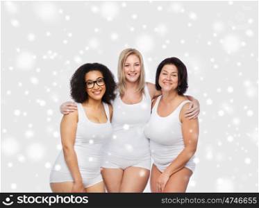 friendship, beauty, body positive and people concept - group of happy plus size women in white underwear over snow