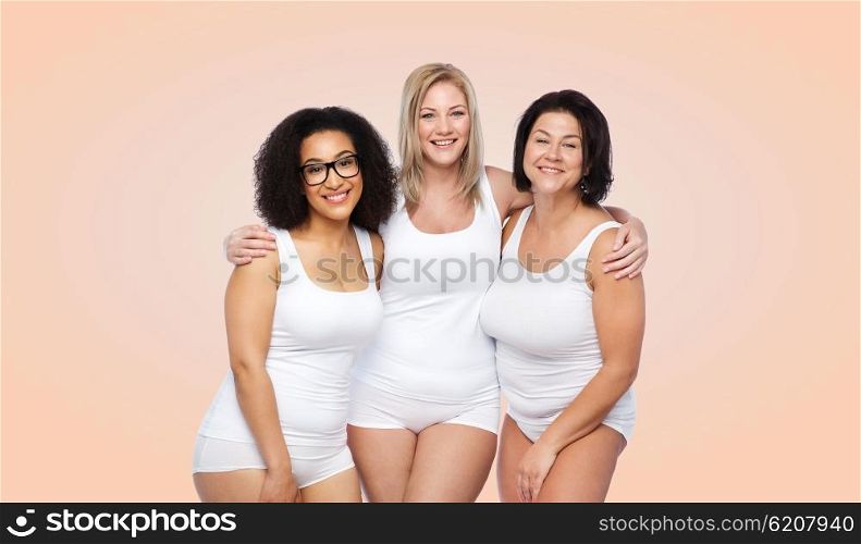 friendship, beauty, body positive and people concept - group of happy plus size women in white underwear over beige background