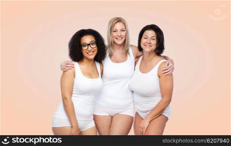 friendship, beauty, body positive and people concept - group of happy plus size women in white underwear over beige background