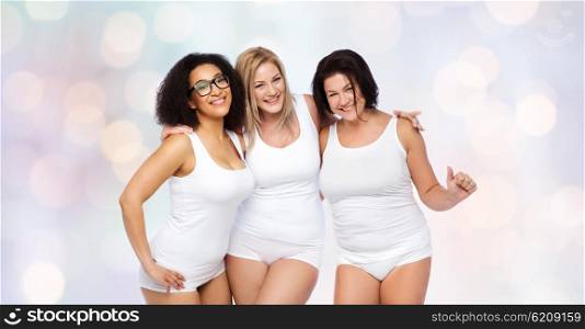 friendship, beauty, body positive and people concept - group of happy plus size women in white underwear over holidays lights background