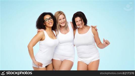 friendship, beauty, body positive and people concept - group of happy plus size women in white underwear over blue background