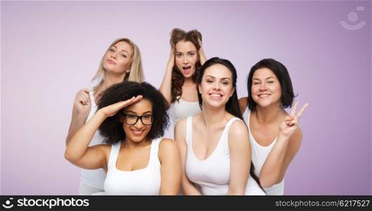 friendship, beauty, body positive and people concept - group of happy plus size women in white underwear having fun and making faces over violet background