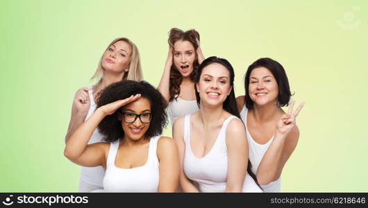 friendship, beauty, body positive and people concept - group of happy plus size women in white underwear having fun and making faces over green natural background