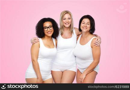 friendship, beauty, body positive and people concept - group of happy plus size women in white underwear over pink background