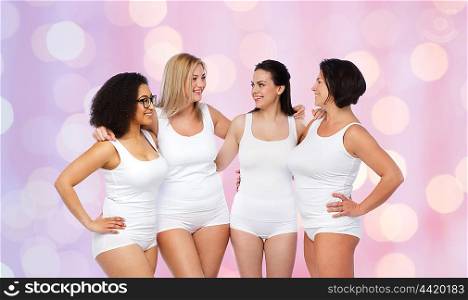 friendship, beauty, body positive and people concept - group of happy women different in white underwear over rose quartz and serenity lights background
