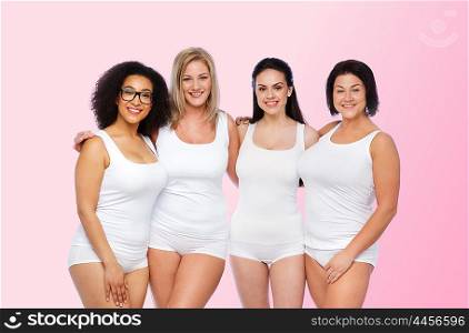 friendship, beauty, body positive and people concept - group of happy women different in white underwear over pink background