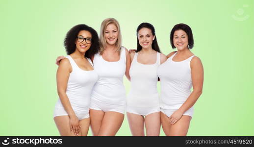 friendship, beauty, body positive and people concept - group of happy women different in white underwear over green natural background